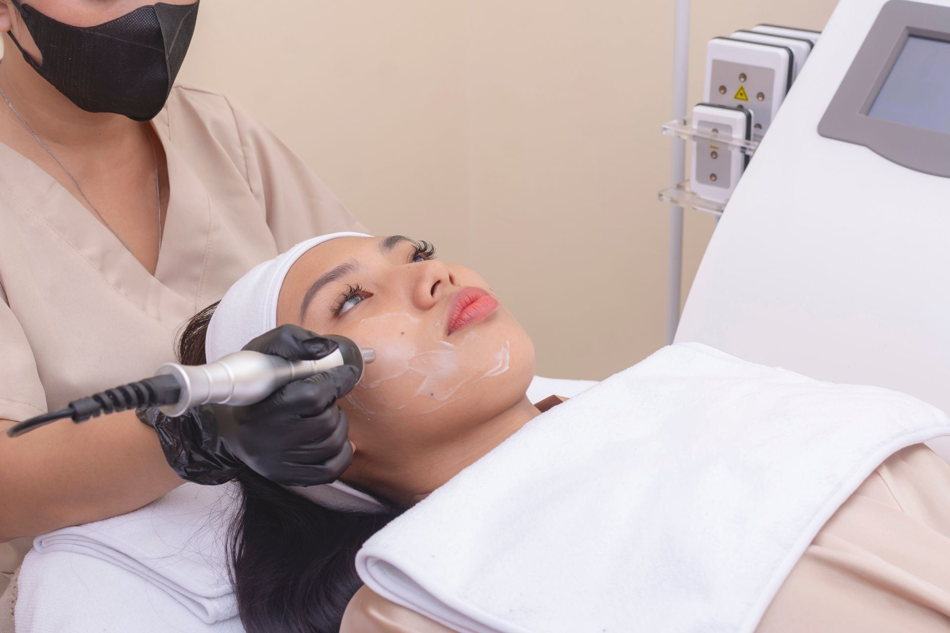 A woman is getting a facial treatment at a beauty salon.