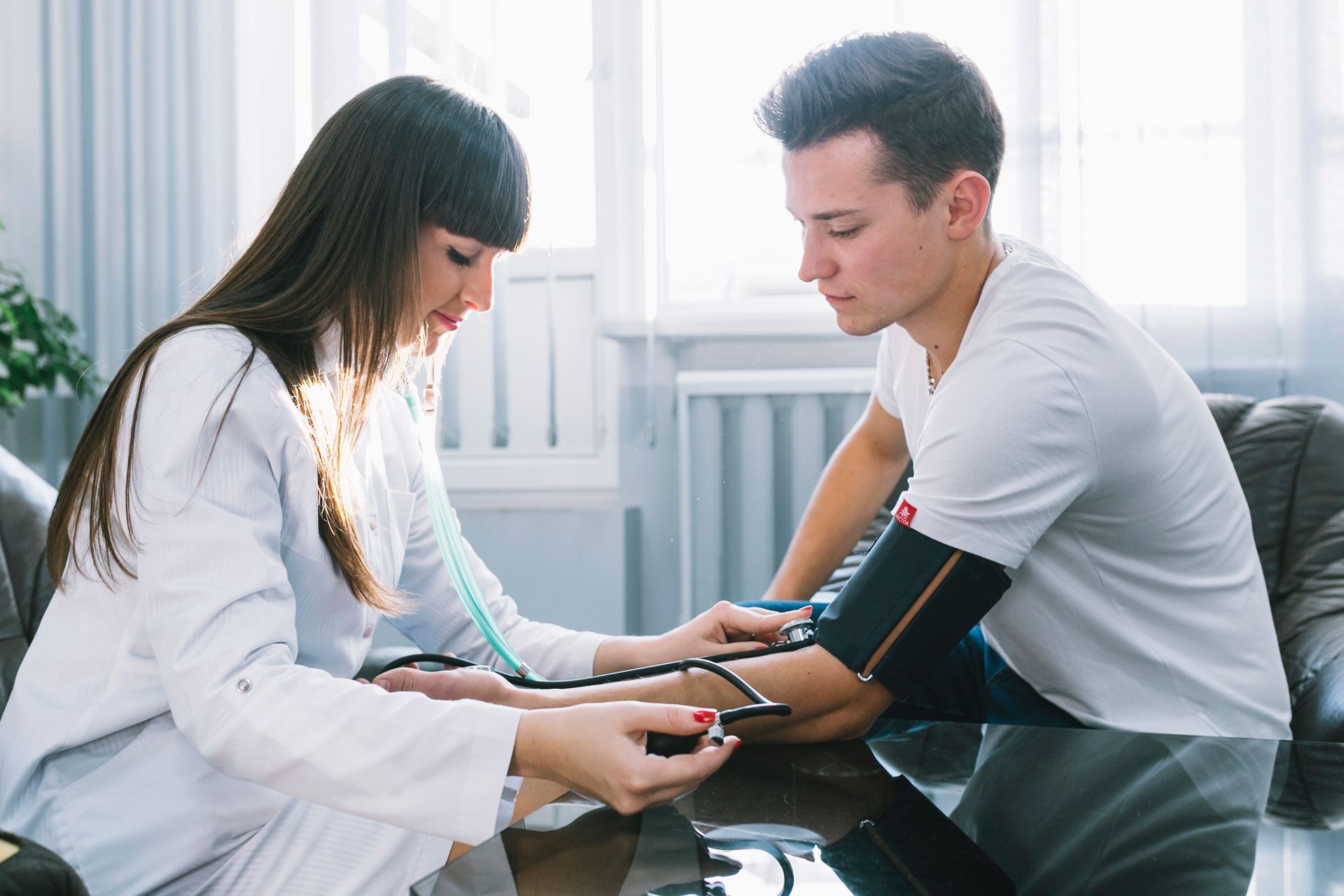 A doctor is checking a patient's blood pressure. 