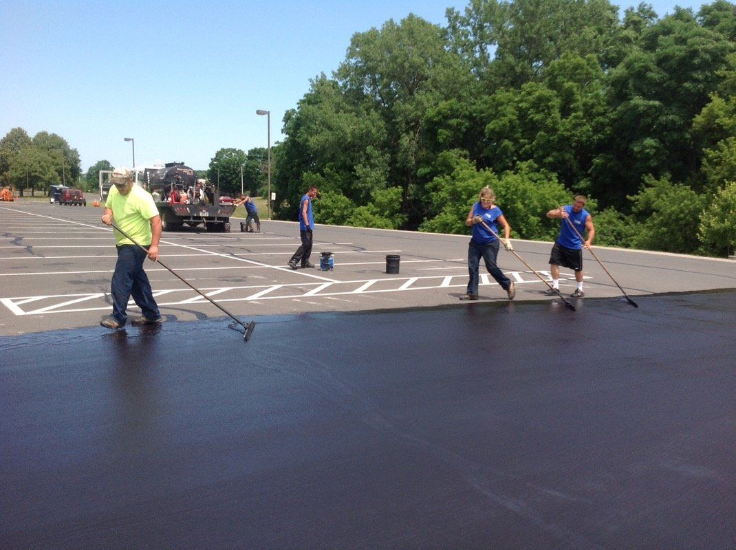 Team Spreading Seal Coating — Syracuse, NY — Dependable Paving Co., Inc.