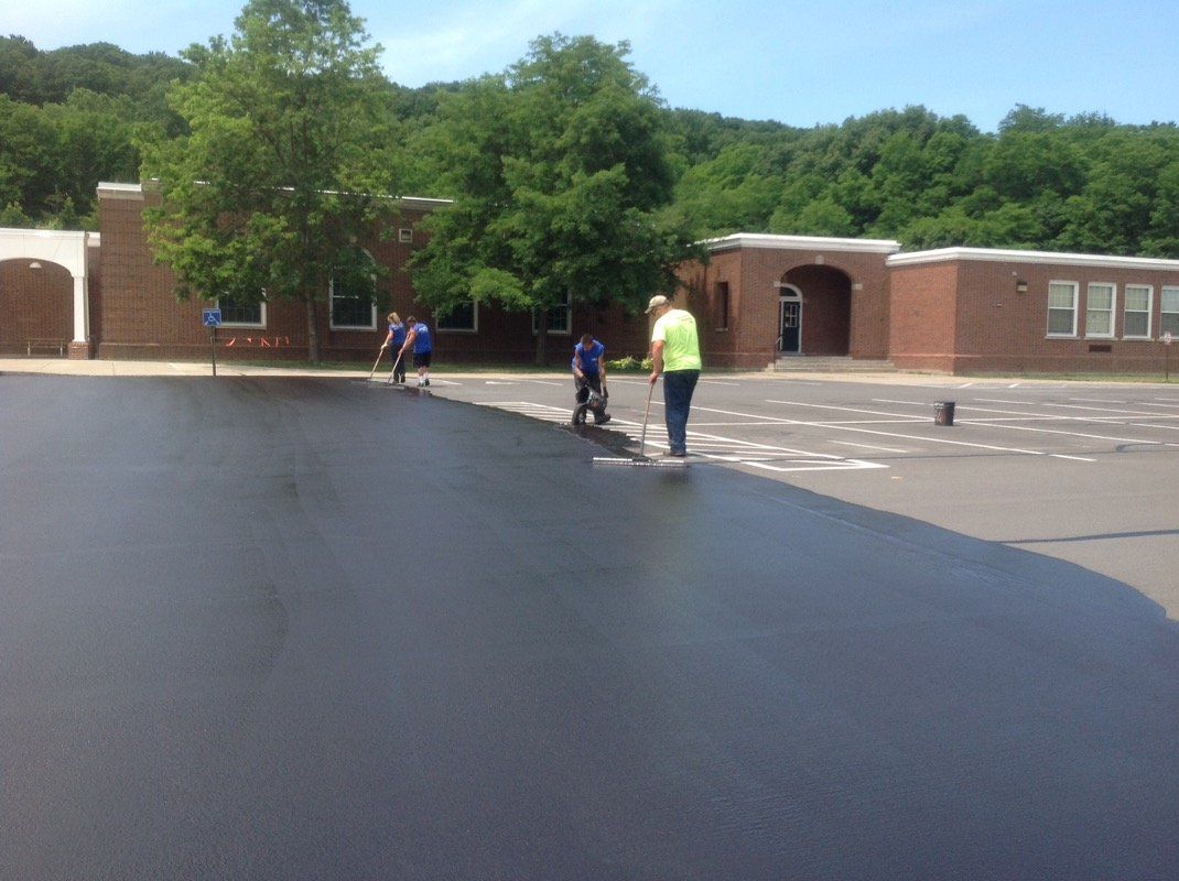 Spreading Seal Coating — Syracuse, NY — Dependable Paving Co., Inc.