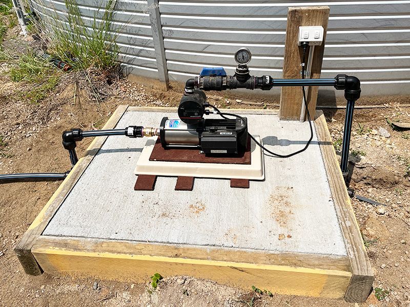 A Water Pump is Sitting on Top of a Wooden Platform — The Pump Doctor In Beerwah, QLD