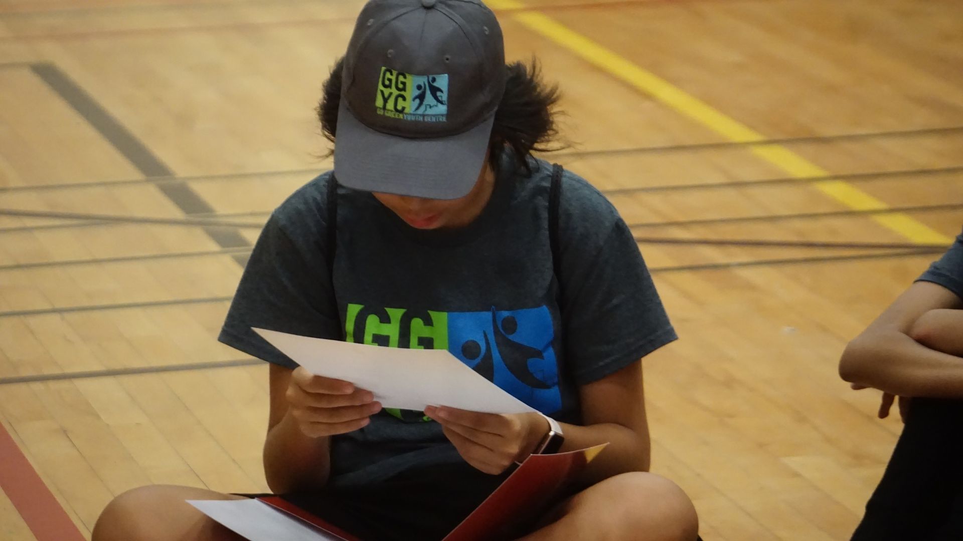 A boy in a black hoodie with the letter s on it