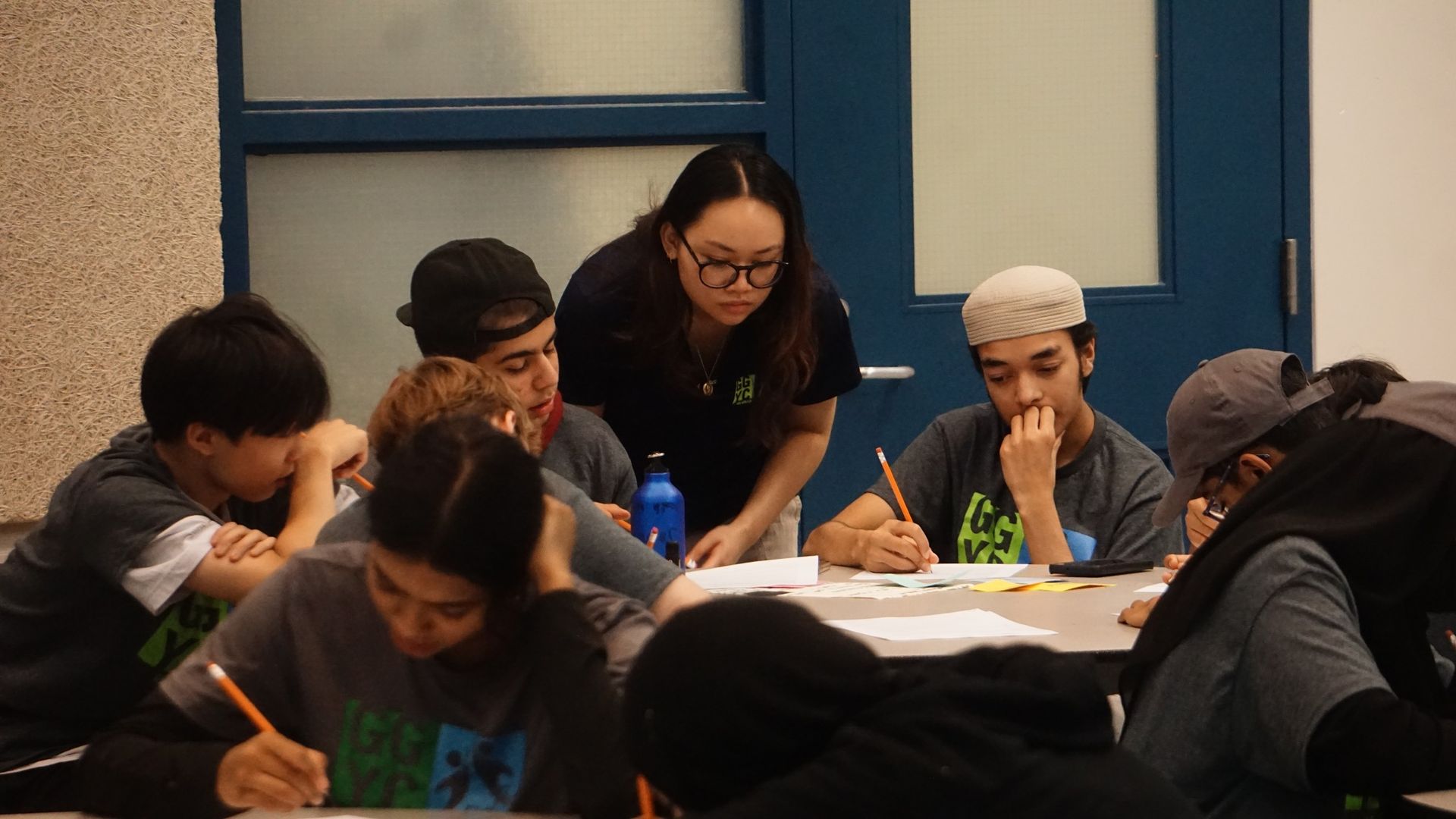 A group of people are playing basketball in a gym.
