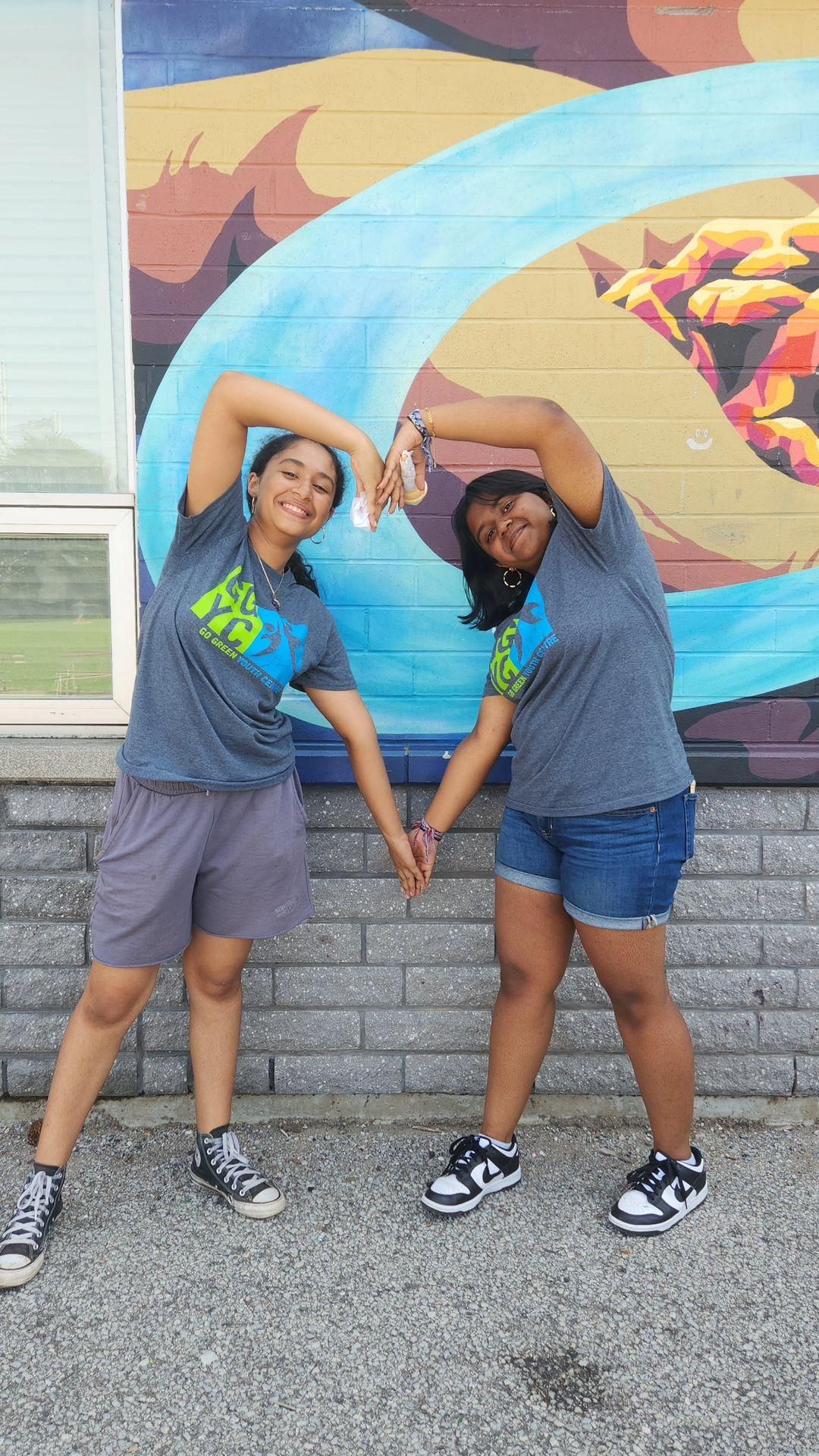A boy in a white shirt is kicking a soccer ball