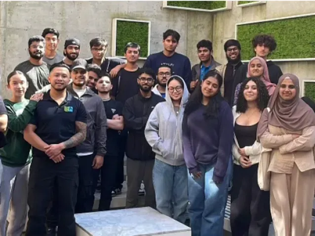 A group of people are posing for a picture together.