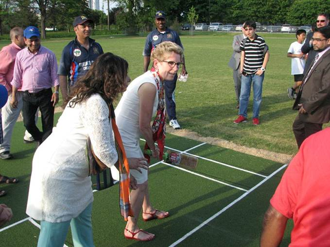 A group of people are playing shuffleboard in a park