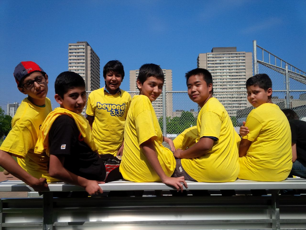 A group of young boys wearing yellow shirts with reebok on them