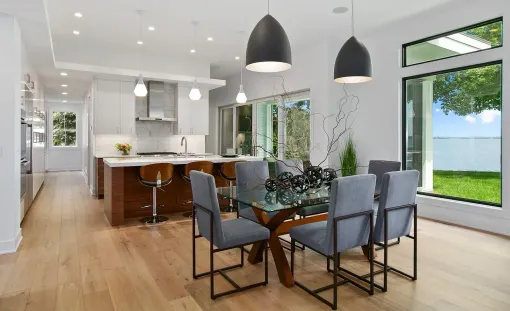 There is a dining room table and chairs in the middle of the room.