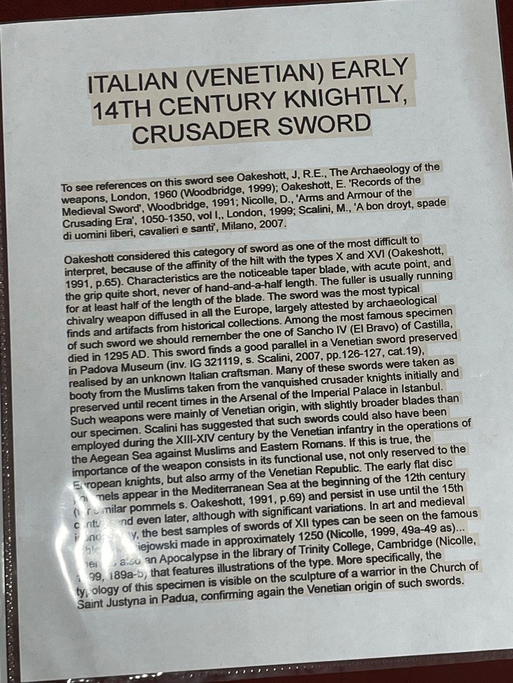 Text on a white paper within a plastic sleeve: 