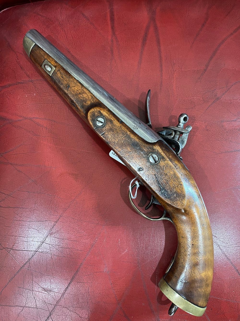 Close-up of a metal barrel with inscribed text: 