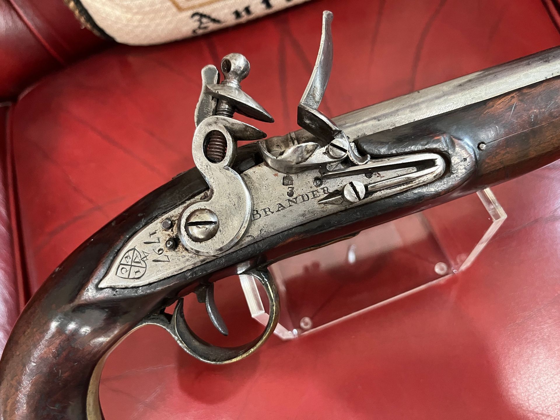 A close up of a silver object on a red surface.