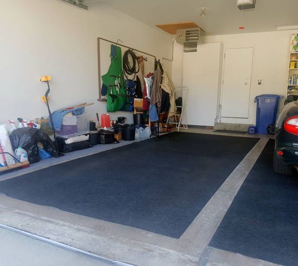 A Clean Garage With A Dark Blue Mat On The Floor — Aiken, NC — Aiken Junkmaster