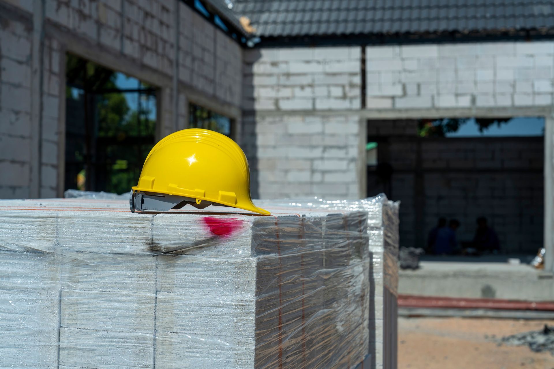 A Yellow Hard Hat On Top Of A Stack Of Concrete Blocks — Aiken, NC — Aiken Junkmaster