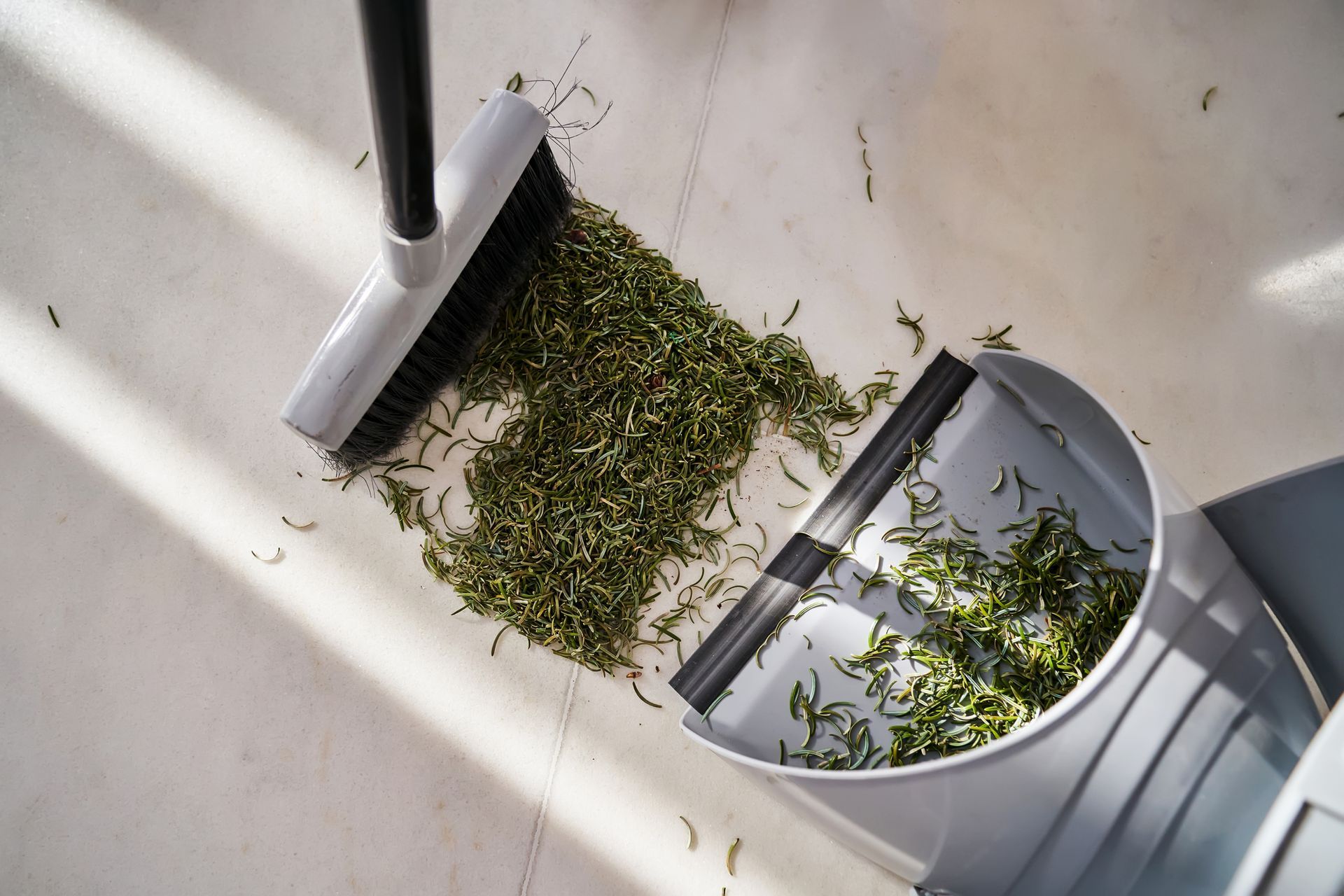 A Broom And Dustpan Are Being Used To Clean The Floor — Aiken, NC — Aiken Junkmaster
