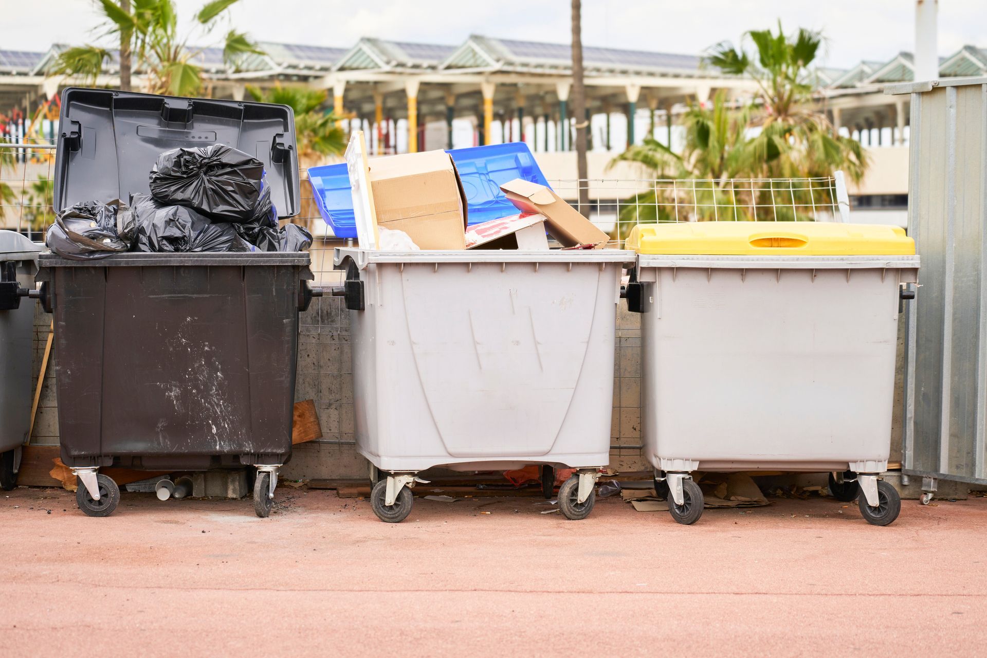 Three Trash Cans Are Lined Up Next To Each Other On A Sidewalk — Aiken, NC — Aiken Junkmaster