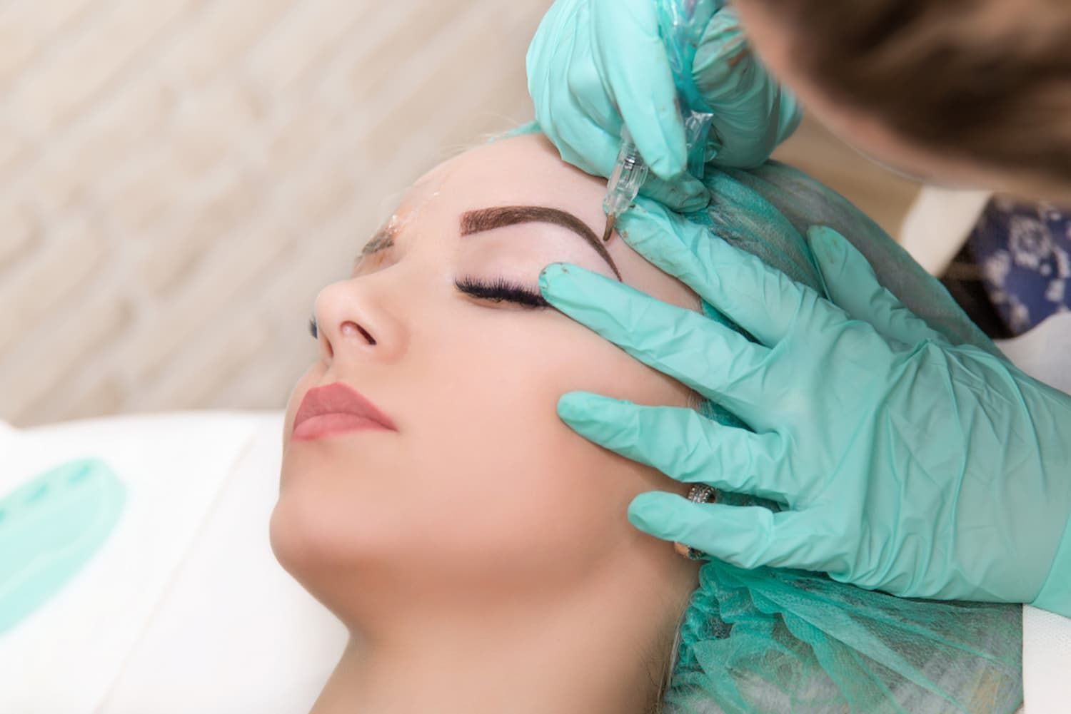 A Woman Is Getting a Permanent Makeup Tattoo on Her Eyebrows β Villa Nails & Beauty in Cannonvale, QLD