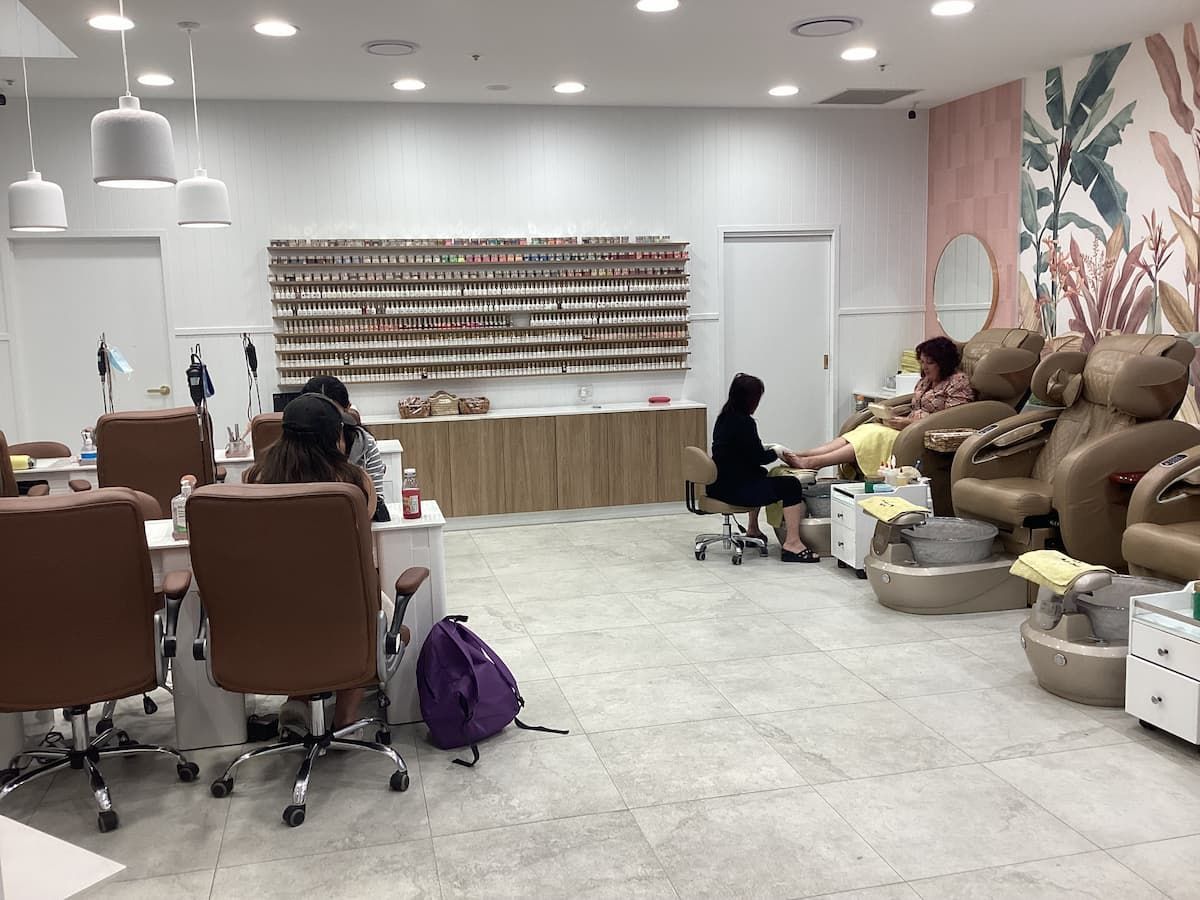 A Woman Is Getting Her Nails Done in A Nail Salon — Villa Nails & Beauty in Cannonvale, QLD
