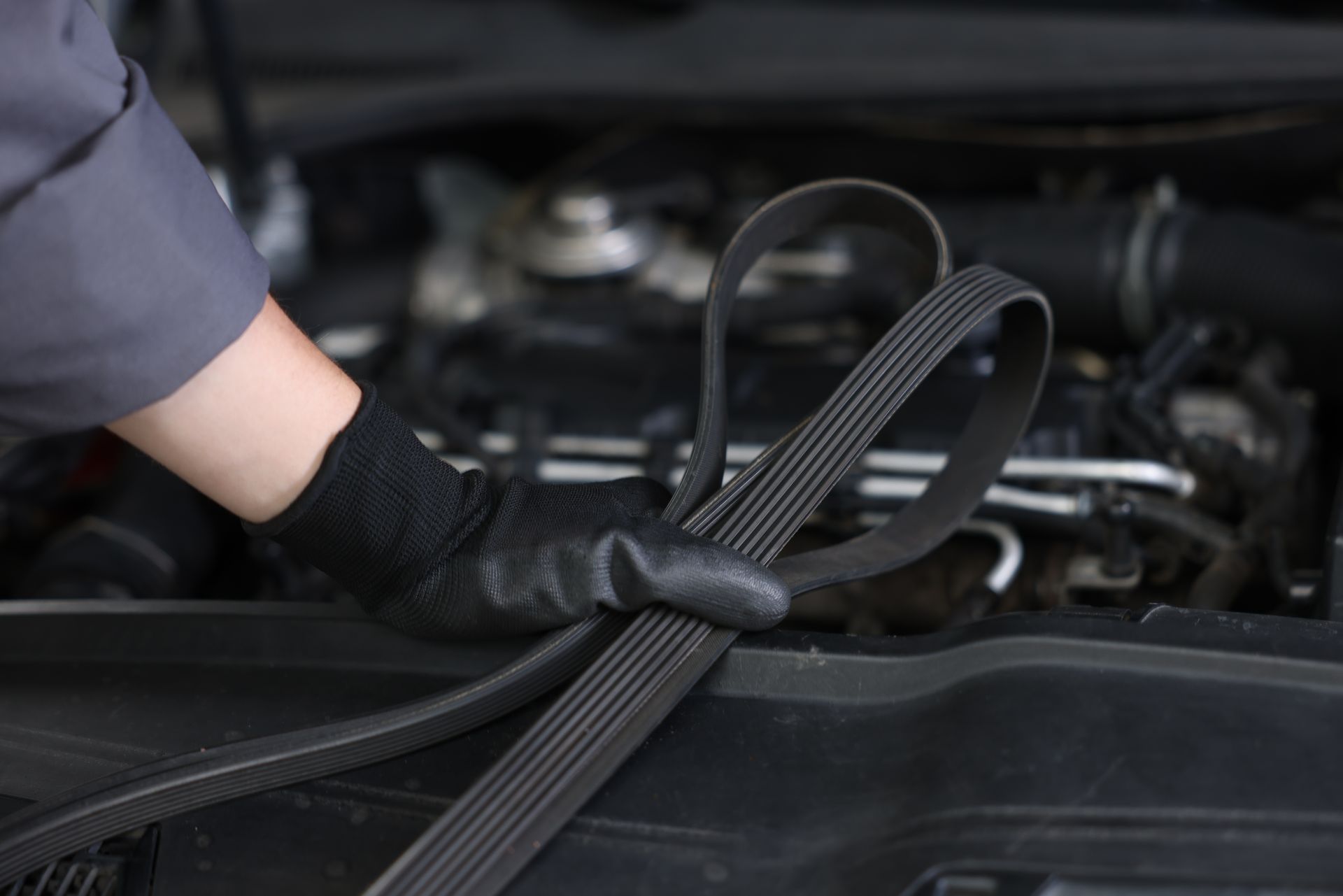 hand holding timing belt for car