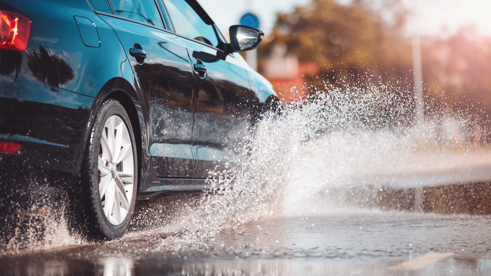 Blue screenwash being poured into a vehicle's screen wash reservoir