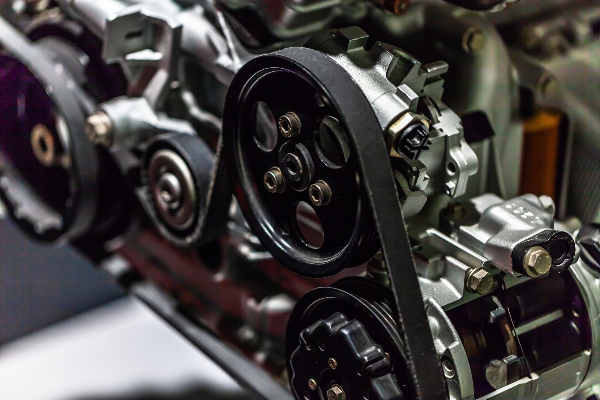 close up image of car timing belt and engine