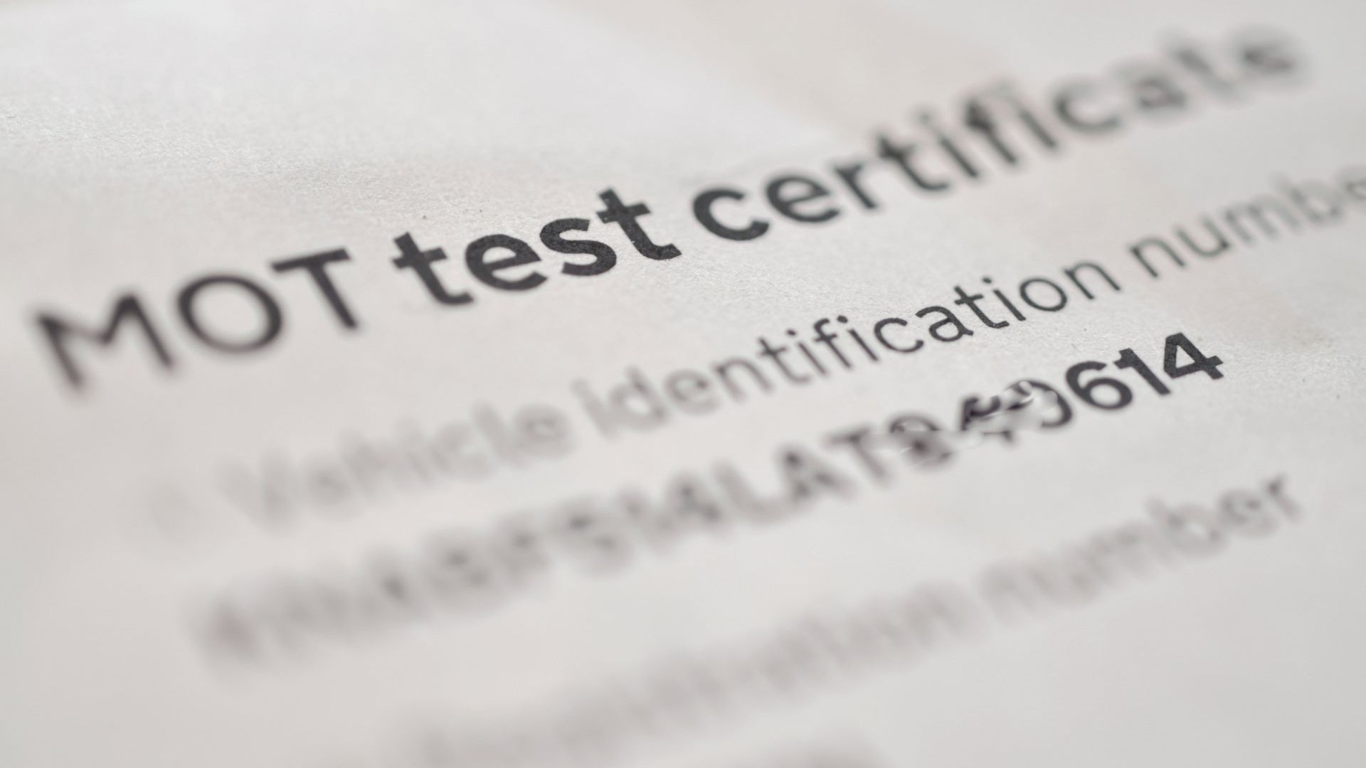 Close up image of an MOT test certificate issued by a garage.