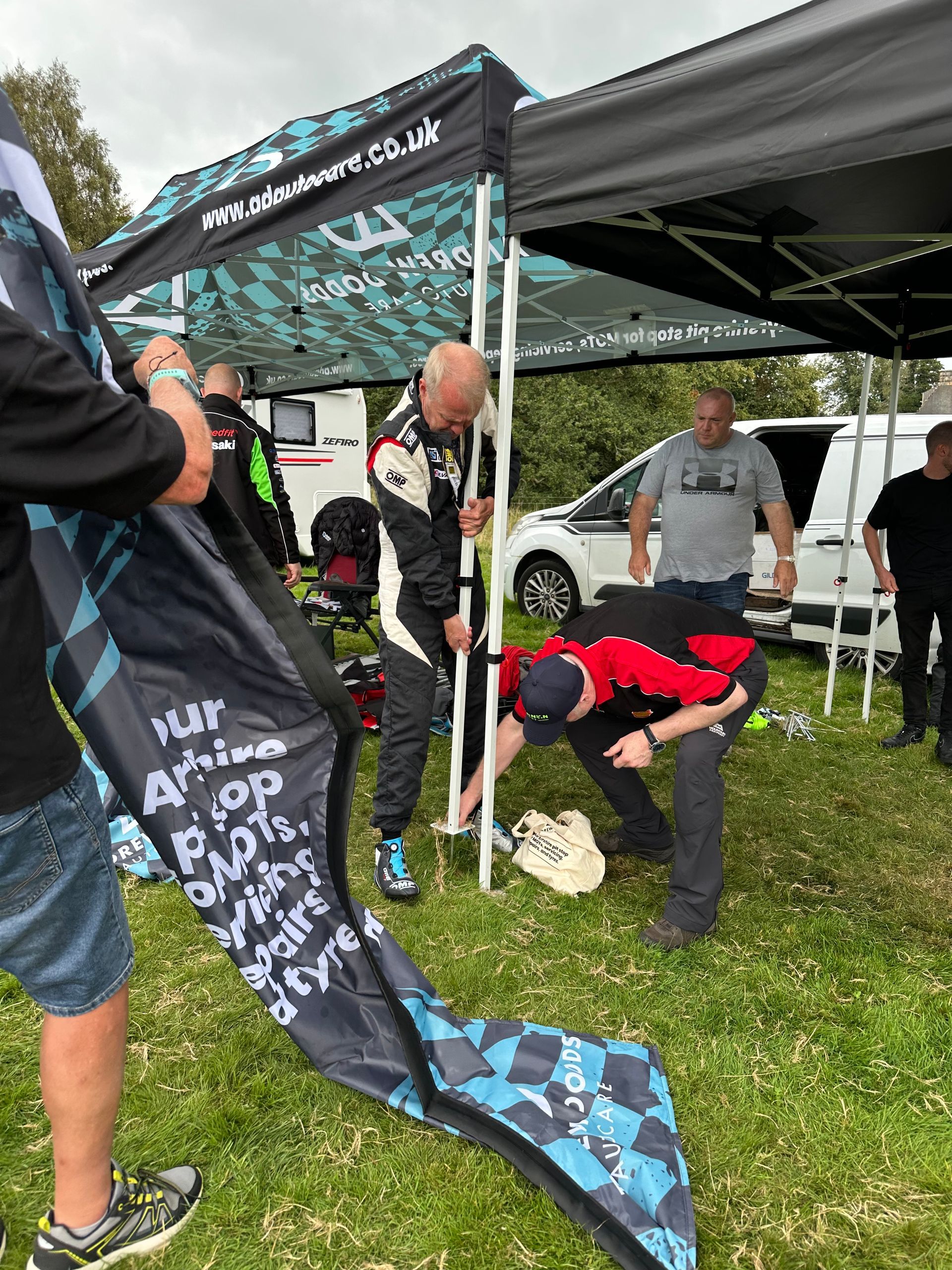 Rally driver helping take down the AD Autocare tent