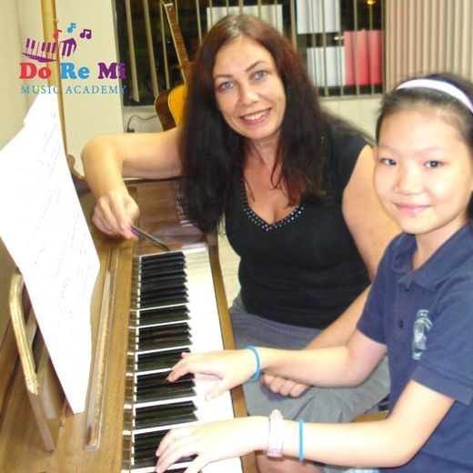 Ms.Barbara  Olszewska a young girl how to play the piano at the Do Re Mi Music Academy