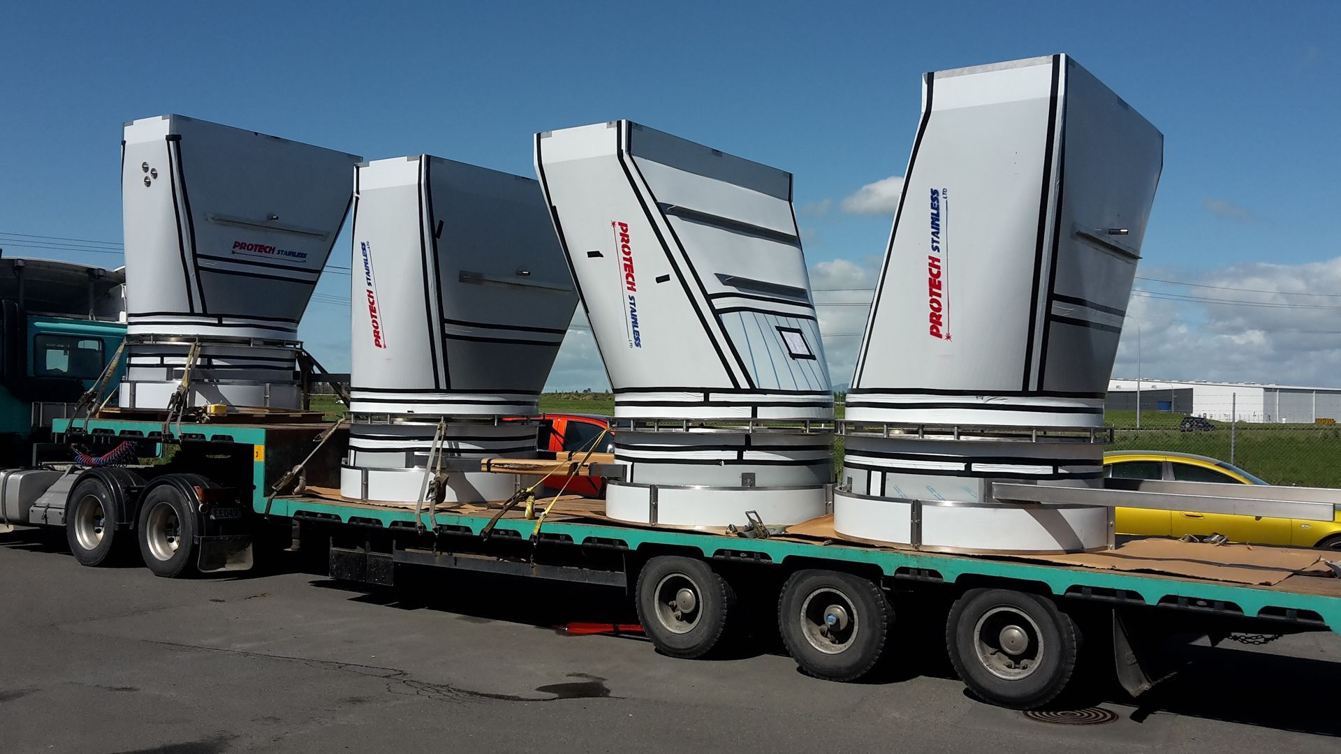 Metal scrollwork pieces on a workbench, ready for assembly, in a workshop setting. Metal scrollwork pieces on a workbench, ready for assembly, in a workshop setting.