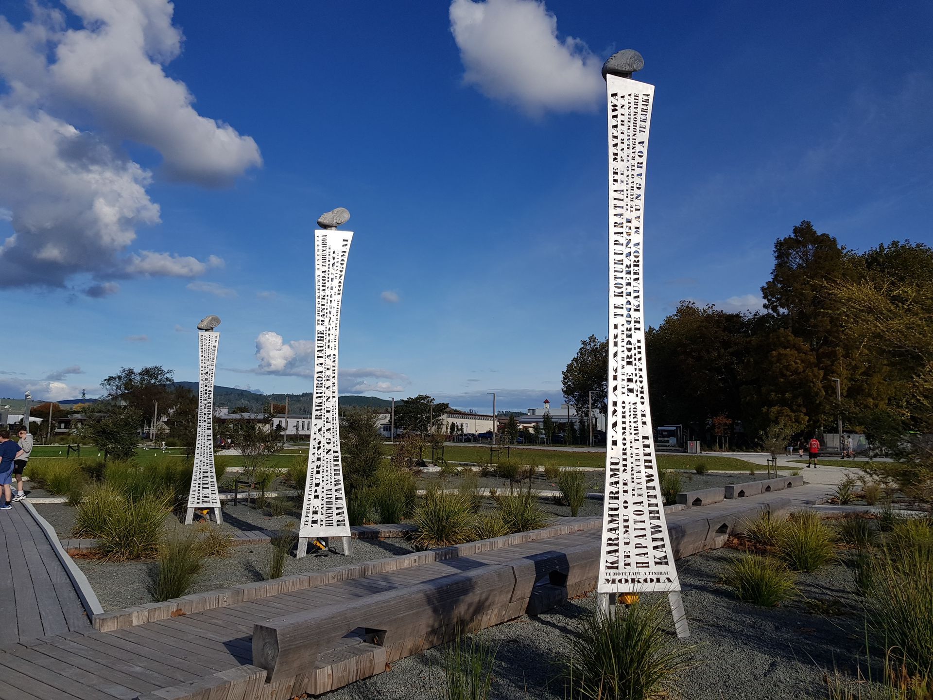 Stainless steel exhaust manifold on a metal table in a workshop.