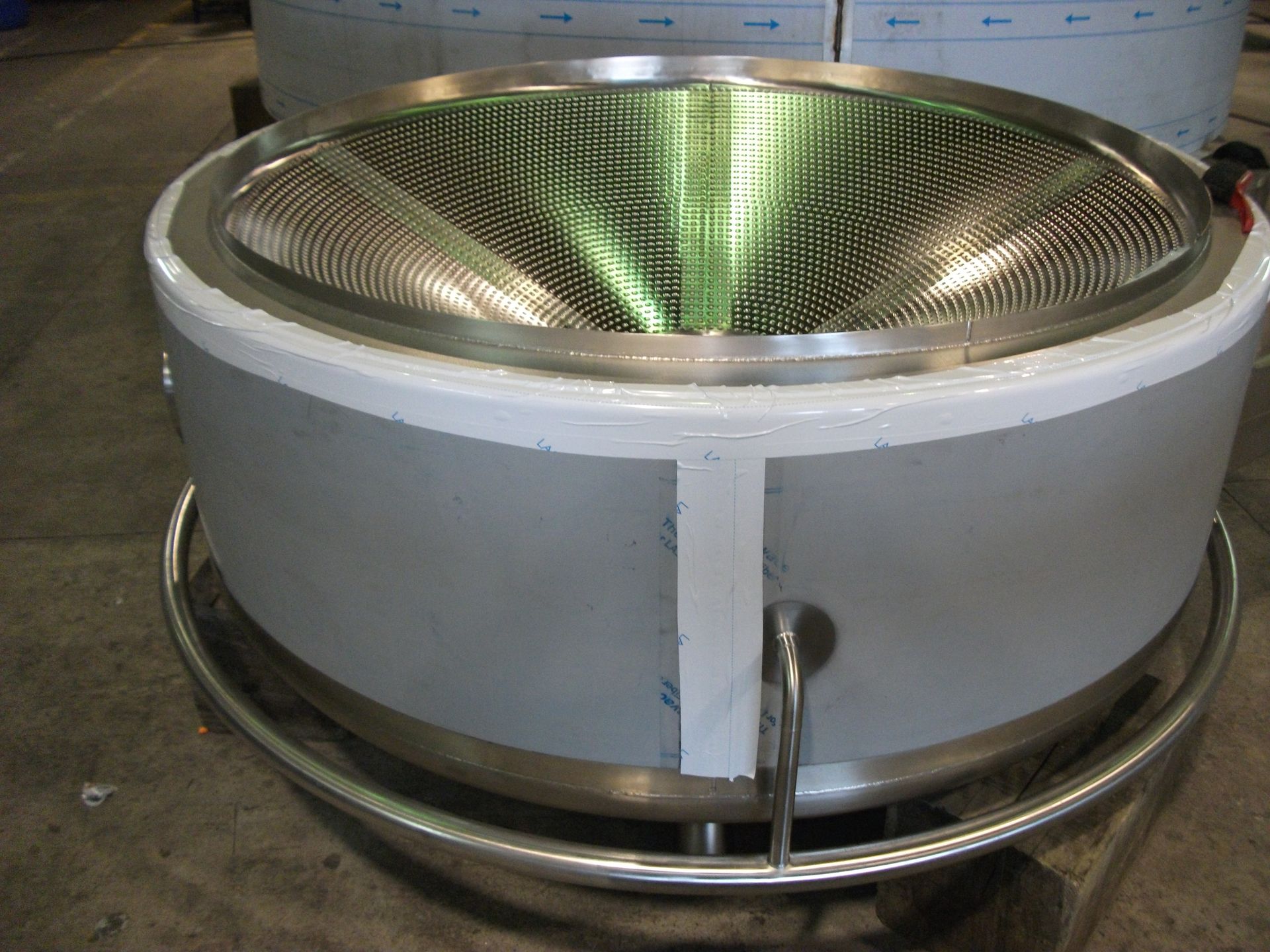 Washer (wash unit) with safety warnings, metal frame, and internal spray nozzles.