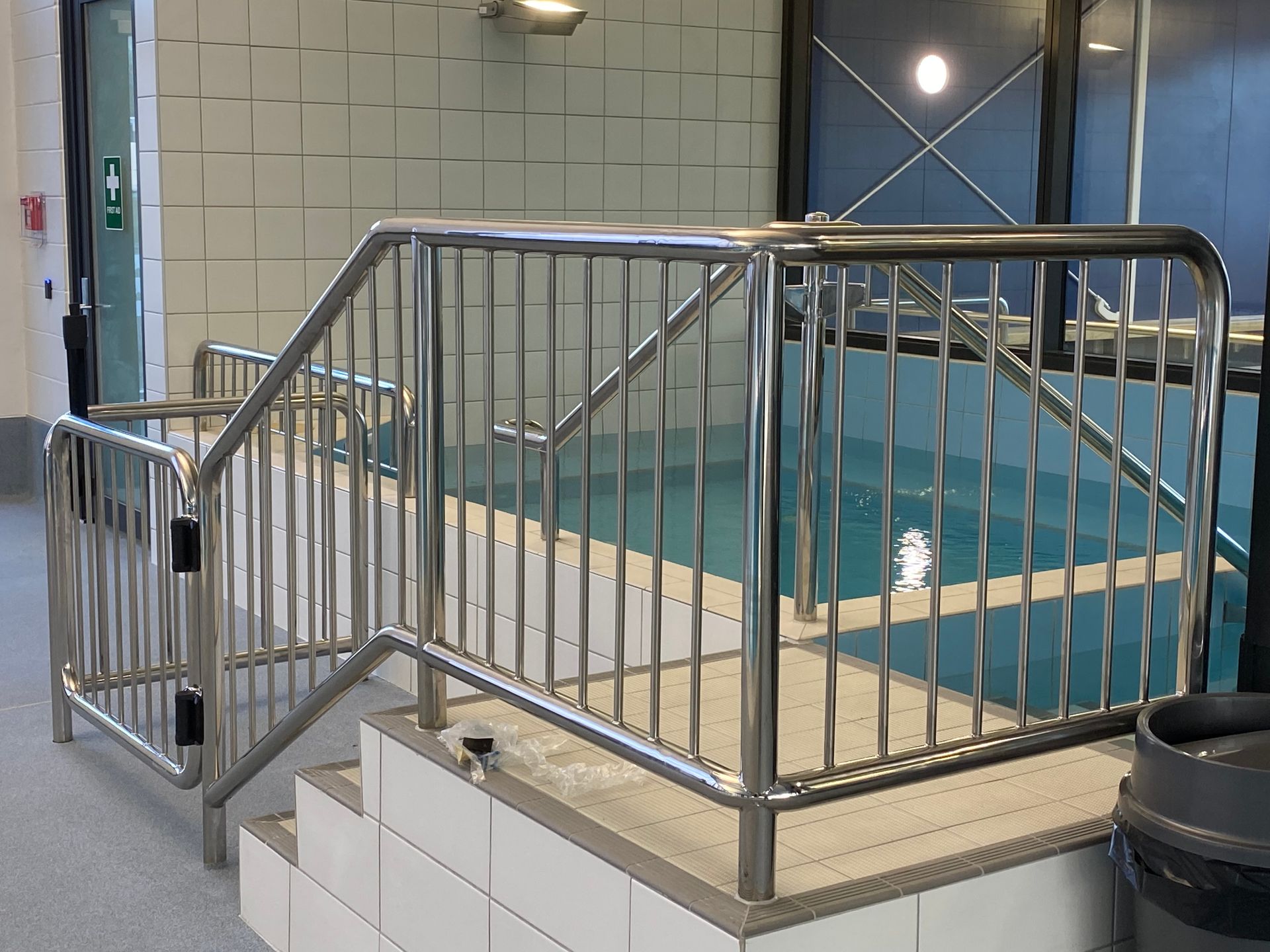 Two stainless steel industrial tanks with angled nozzles, on a steel frame, in a workshop setting. Two stainless steel industrial tanks with angled nozzles, on a steel frame, in a workshop setting.