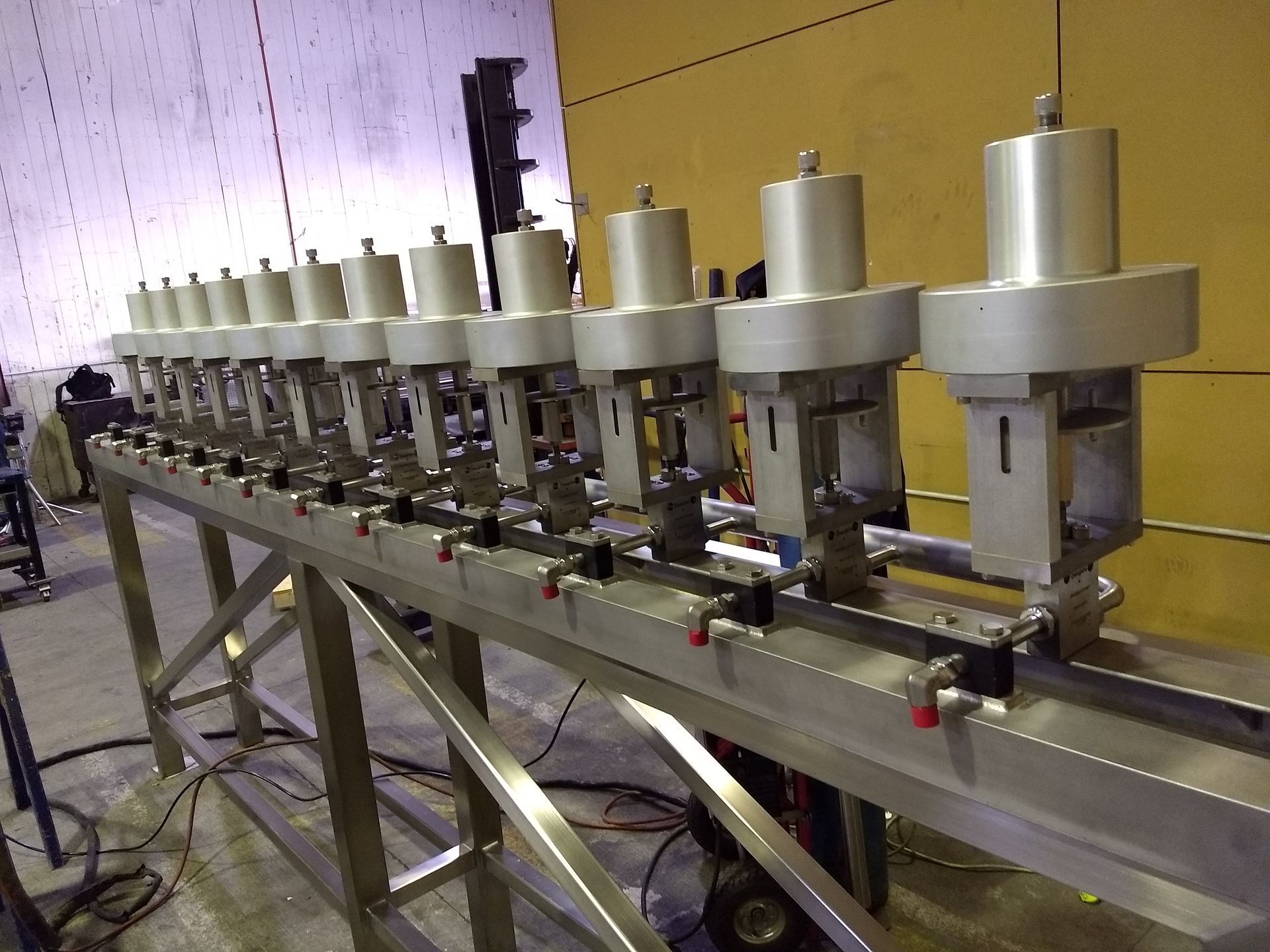 Truck with a large cylindrical tank outside building labeled Truck with a large cylindrical tank outside building labeled