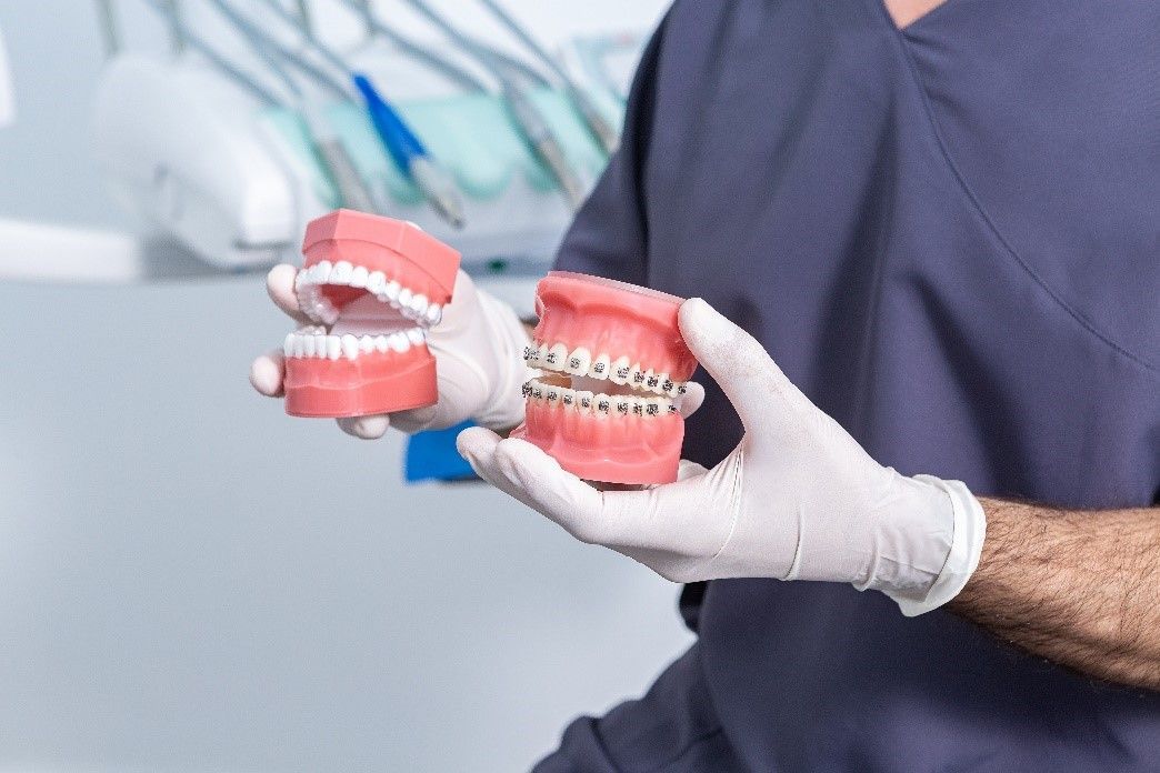 Dentist showing two full sets of dentures