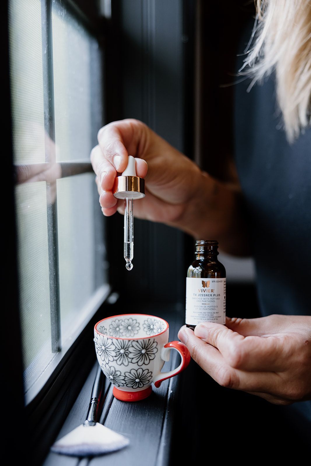 woman holding skincare product