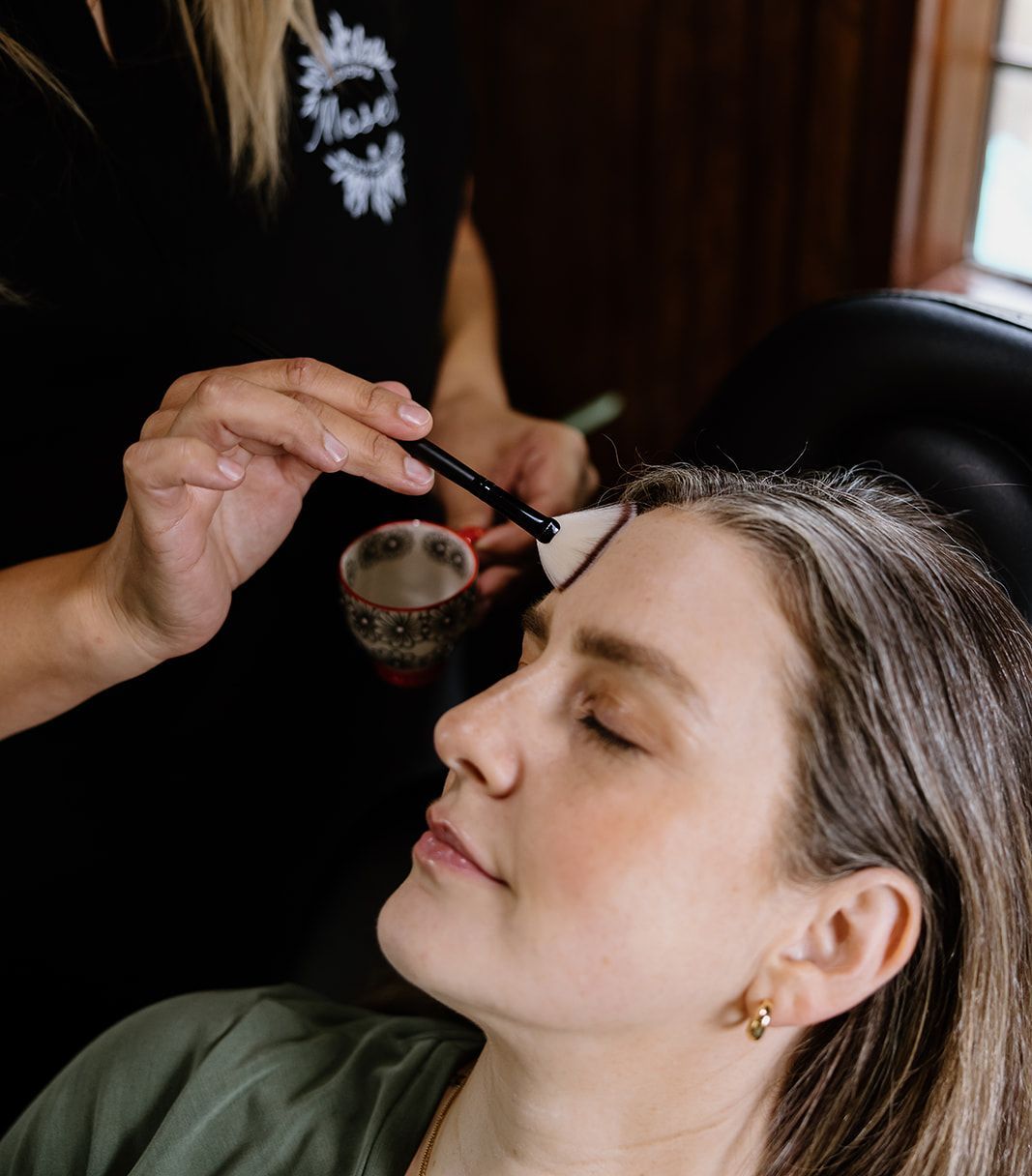 A woman is getting chemical peel treatment