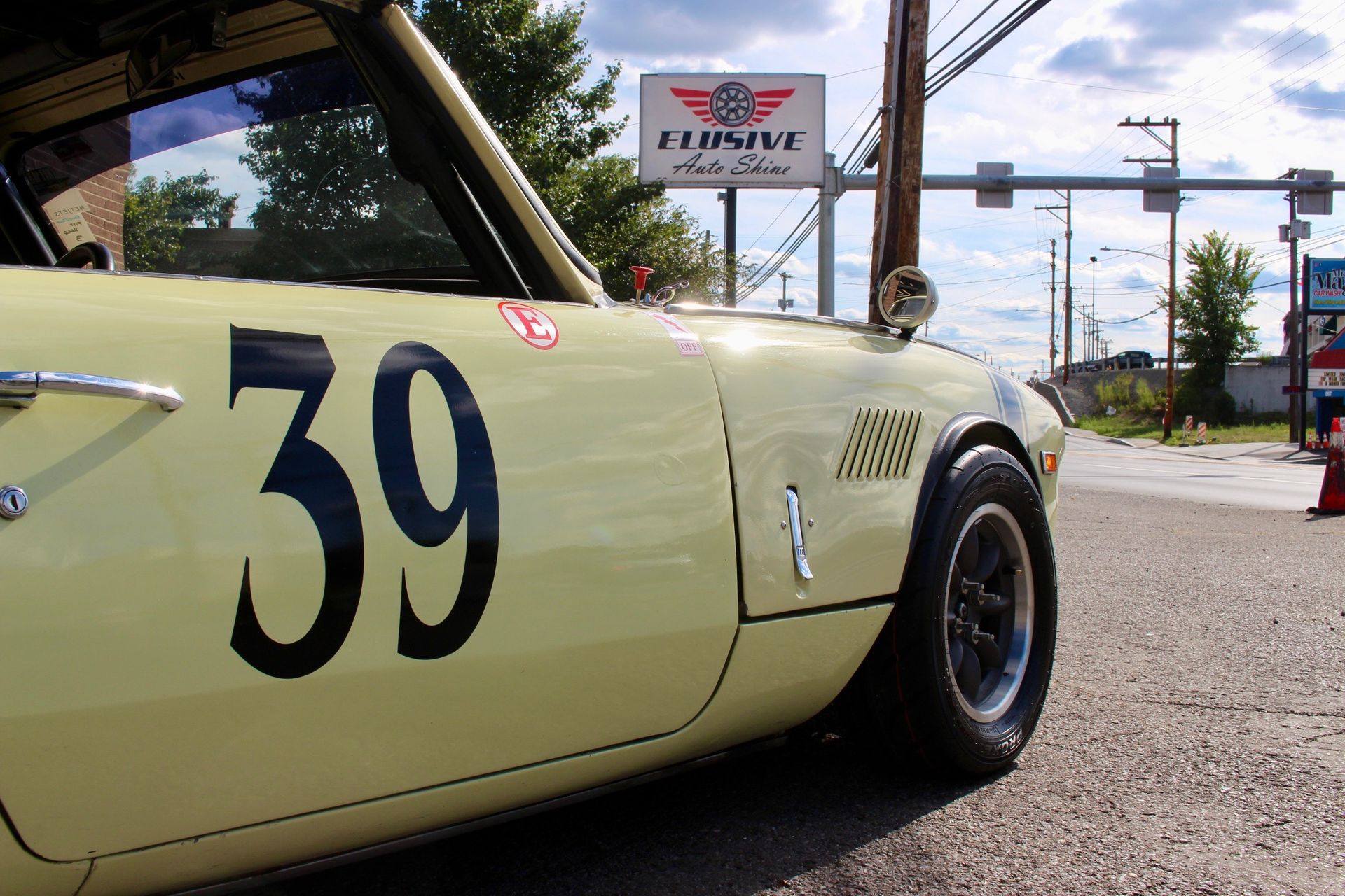 classic race car elusive auto shine parked outside