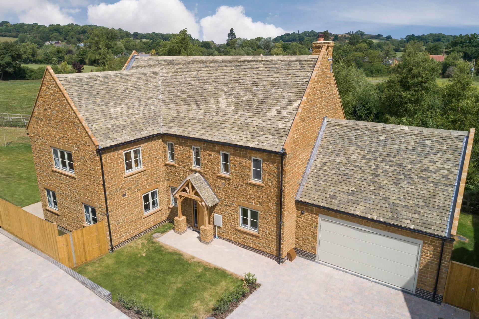 Brailes, An aerial view of a large brick house with a slate roof