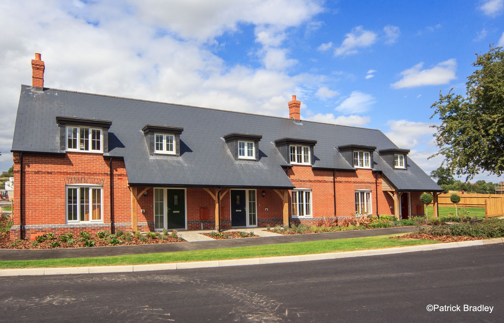 Limetree Village, A brick house with a slate roof and a lot of windows