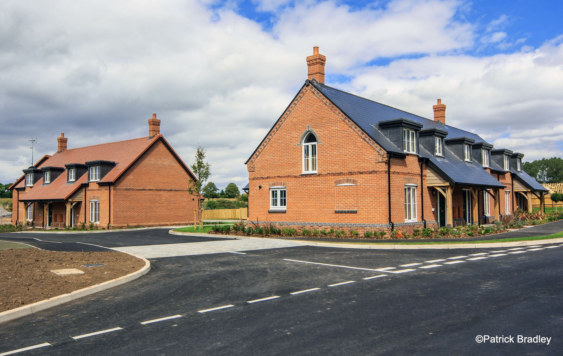 Limetree Village, Two brick houses are sitting next to each other on the side of a road.