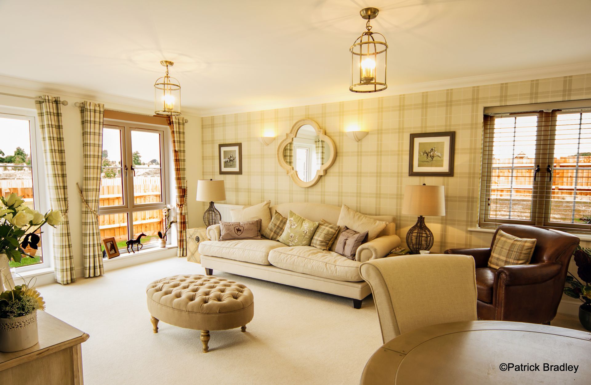 Limetree Village, A living room with a couch , chairs , ottoman and lamps.