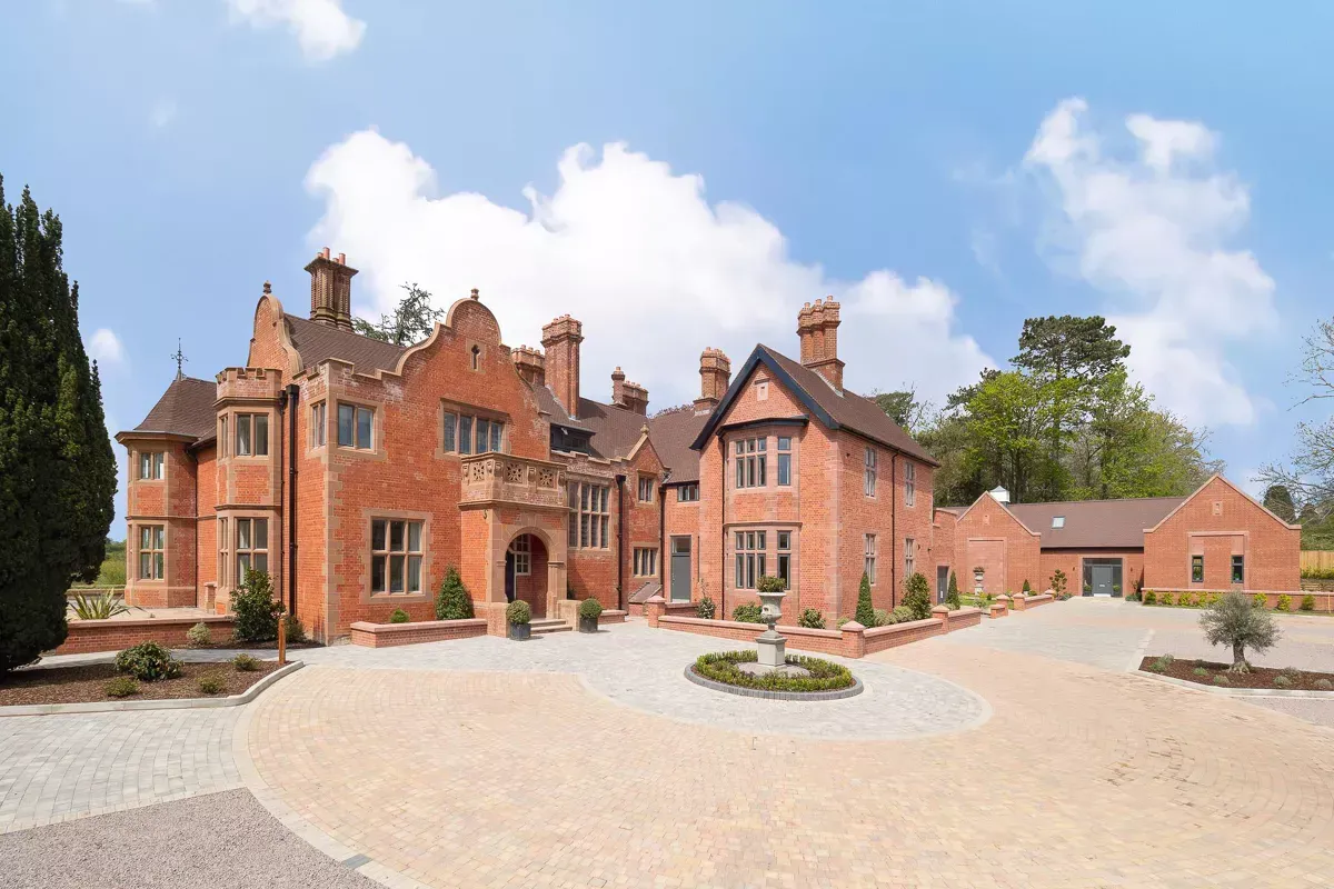 Milverton Hall, a large brick house with a gravel driveway in front of it