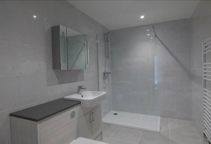 Brailes, A bathroom with a sink , toilet and walk in shower.