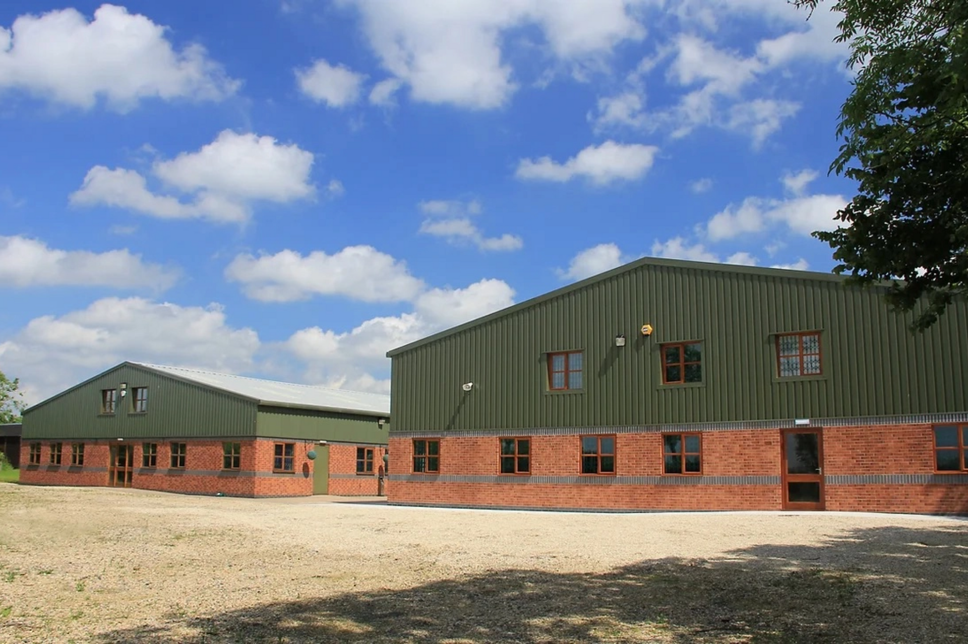 A large brick building with a green roof