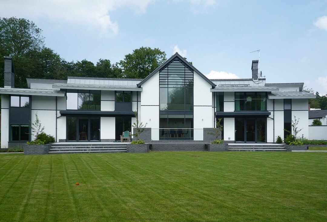 A large white house with a large lawn in front of it