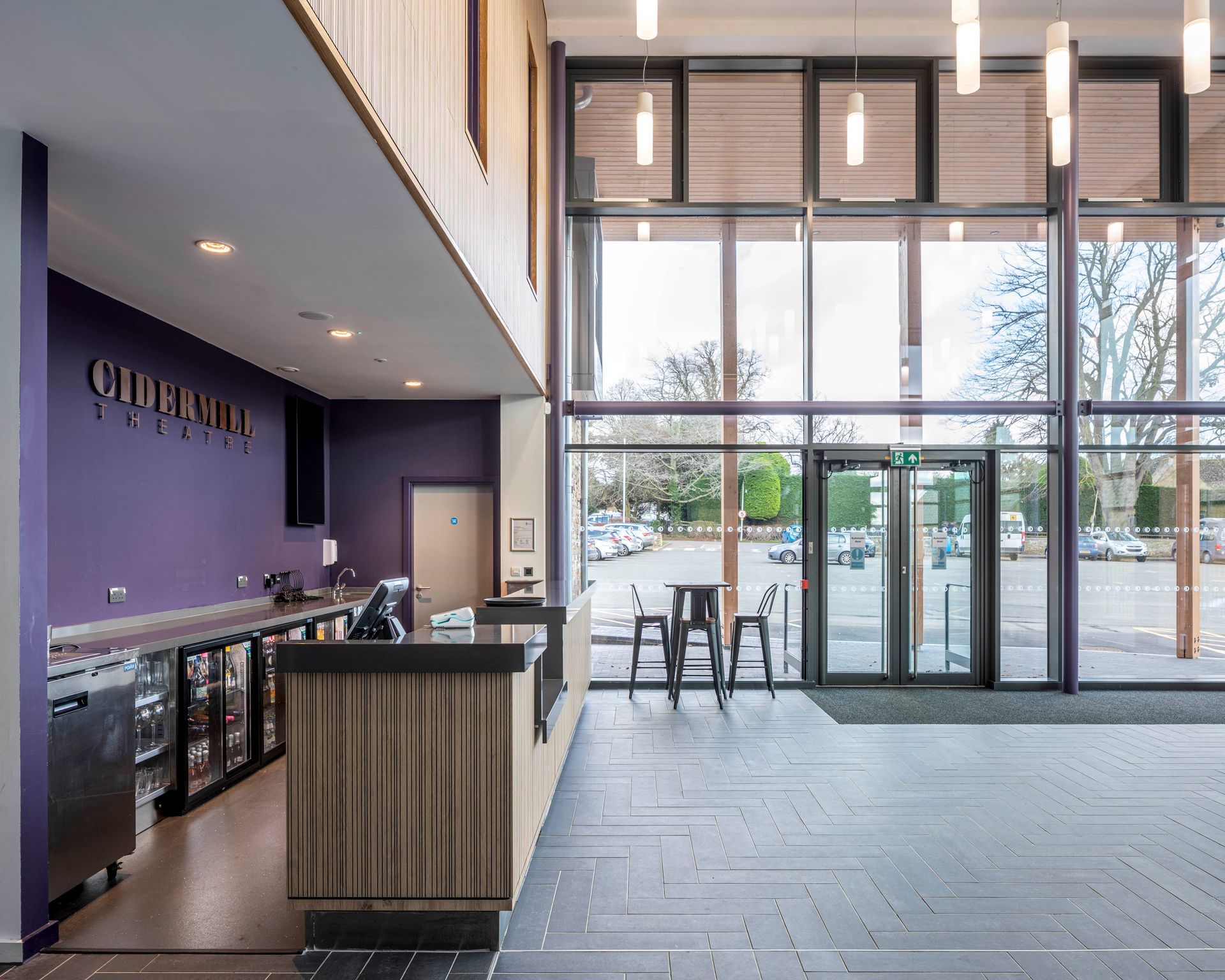 Chipping Campden, A large lobby with a purple wall and a wooden counter.