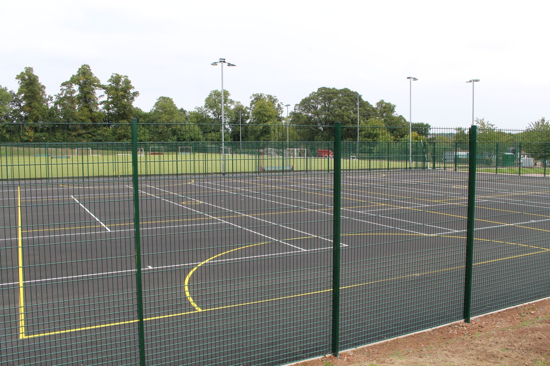 Princethorpe College, A fence surrounds a basketball court in a park
