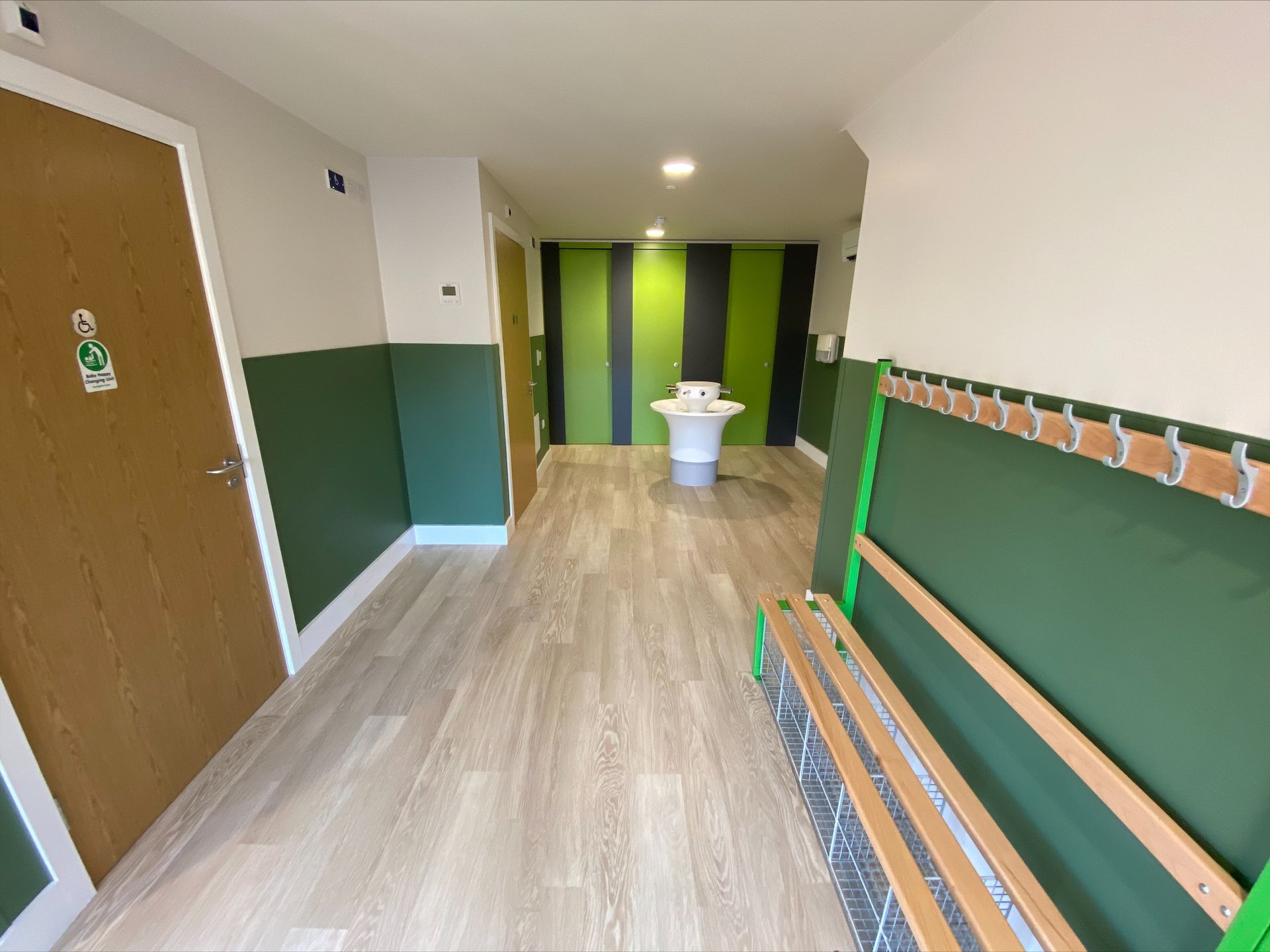 Gorcott Hill Park, A long hallway with green walls and a bench in the middle.