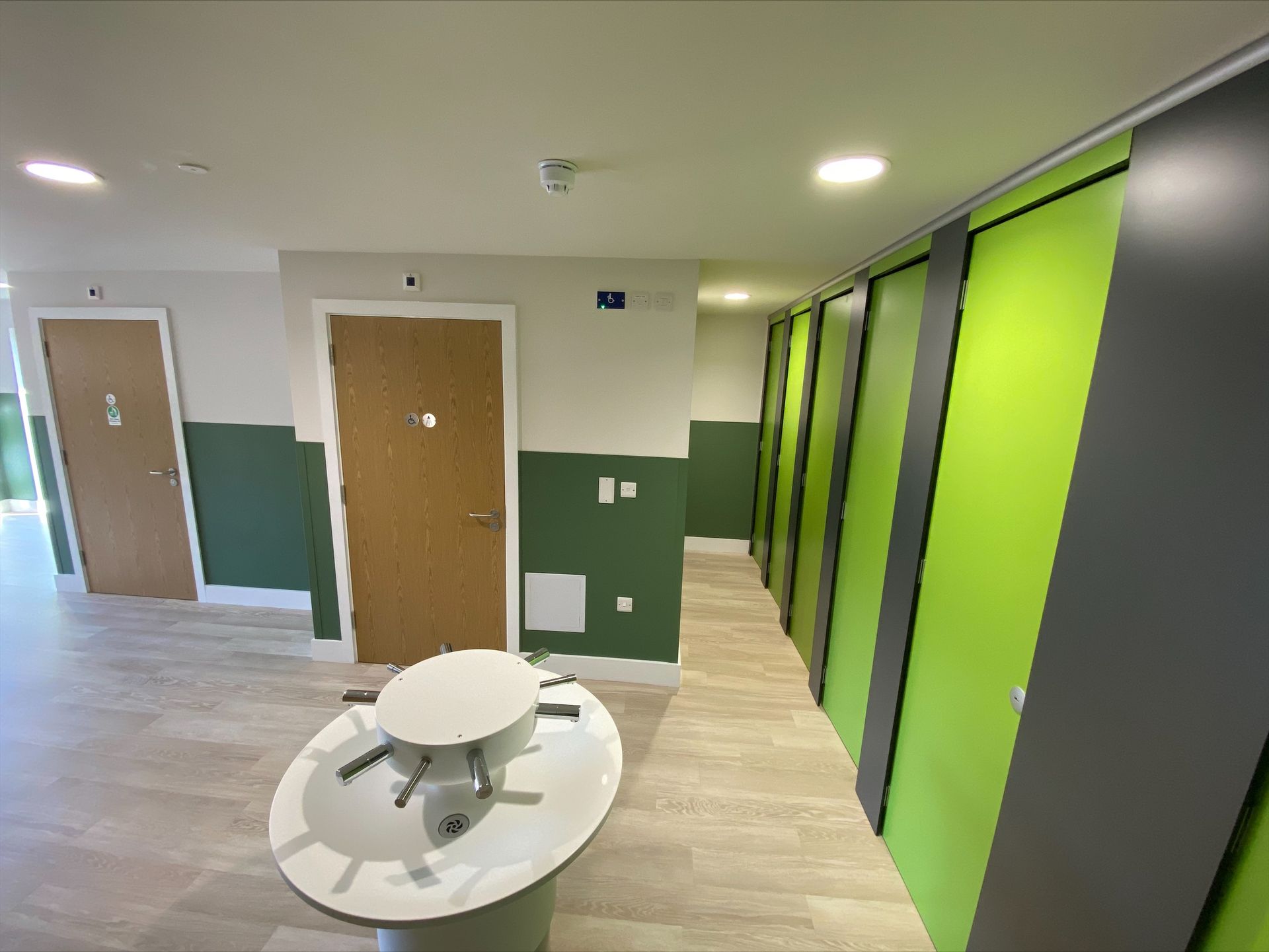 Gorcott Hill Park, A hallway with green and white walls and a sink in the middle.