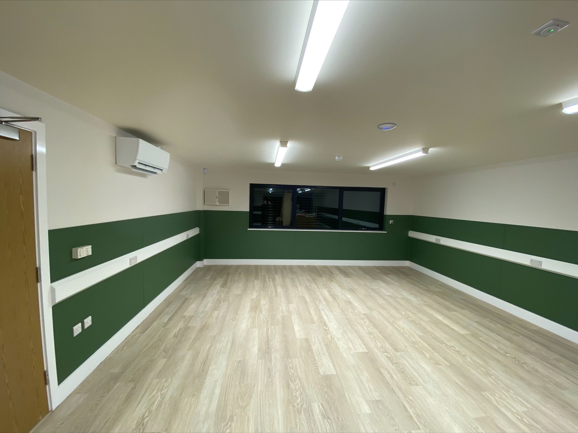 Gorcott Hill Park, An empty room with green walls and a wooden floor.