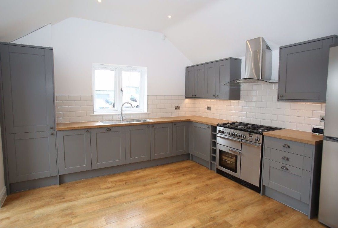 Newbold Farm,  A kitchen with gray cabinets and stainless steel appliances